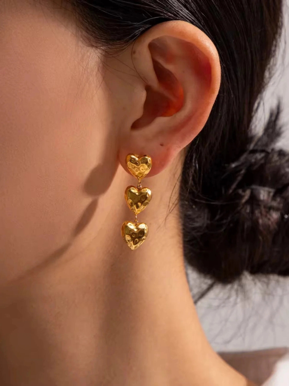 Ashley Heart Earring worn on ear — 18K gold-plated stainless steel heart-design by Shine With Me styled look