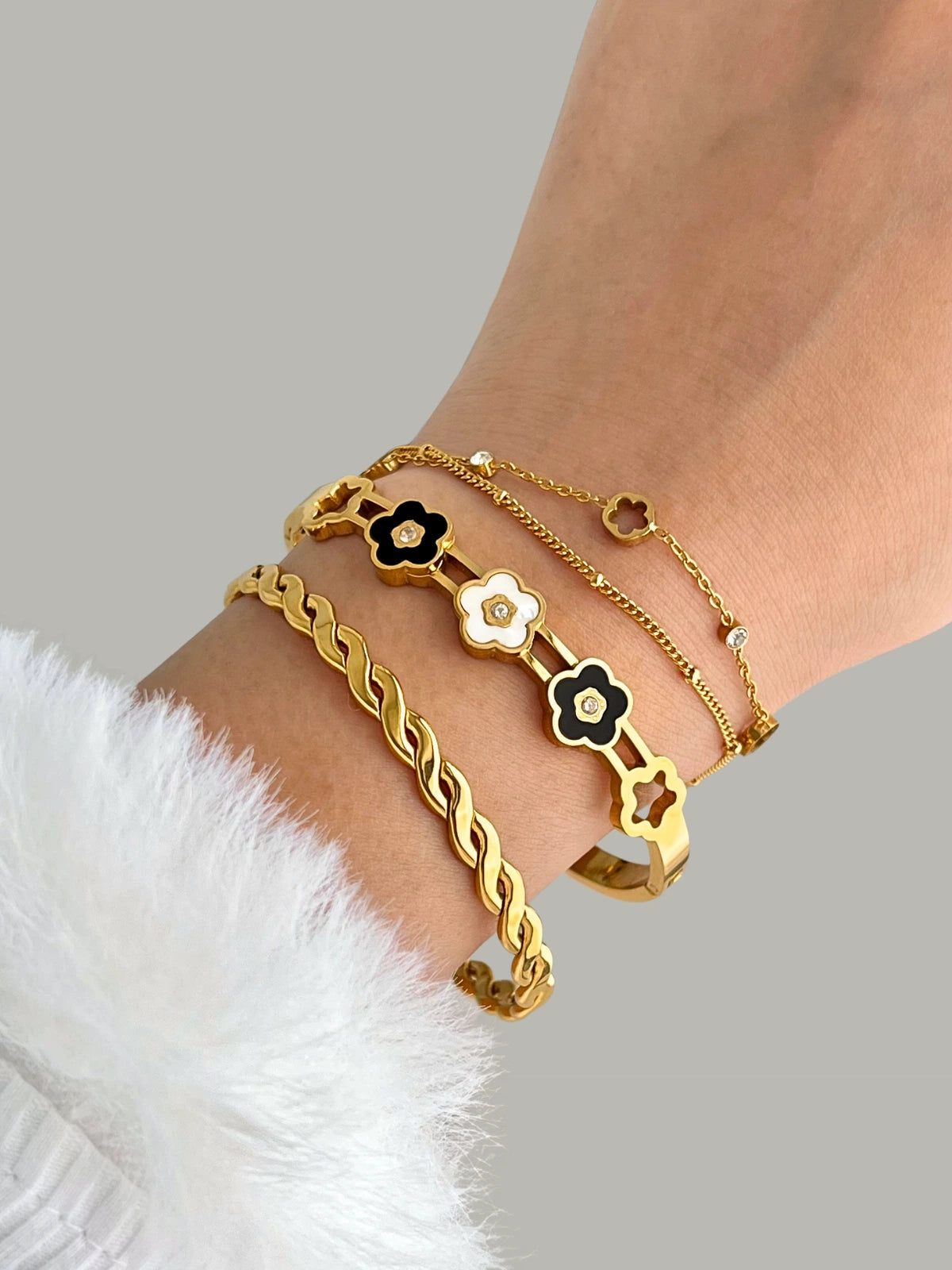Blooming Bangle worn on wrist — 18K gold-plated stainless steel bangle (65 mm) by Shine With Me, styled look.