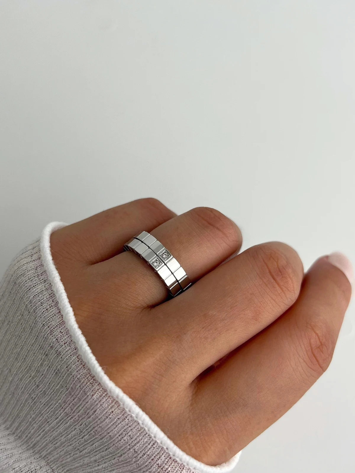 Celina RING-Silver ring on a finger with a plain background