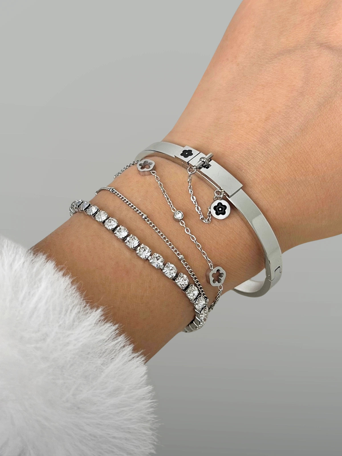 Cosmic Bracelet – On Wrist-Silver bracelets on a wrist with a gray background