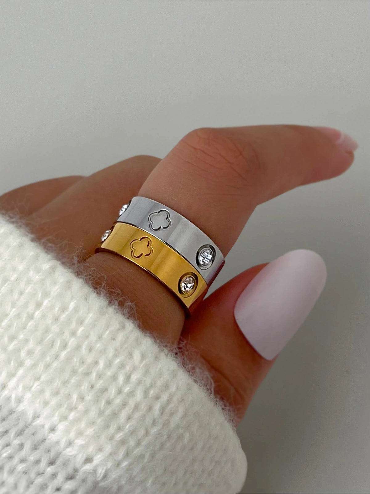 Dawn Ring – Lifestyle / Everyday Look-Gold and silver ring with diamond accents on a finger against a neutral background