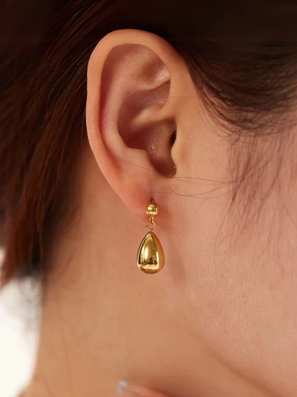 Demi Drop Earrings worn on ear — 18K gold‑plated stainless steel, size 17 mm, by Shine With Me, styled look.