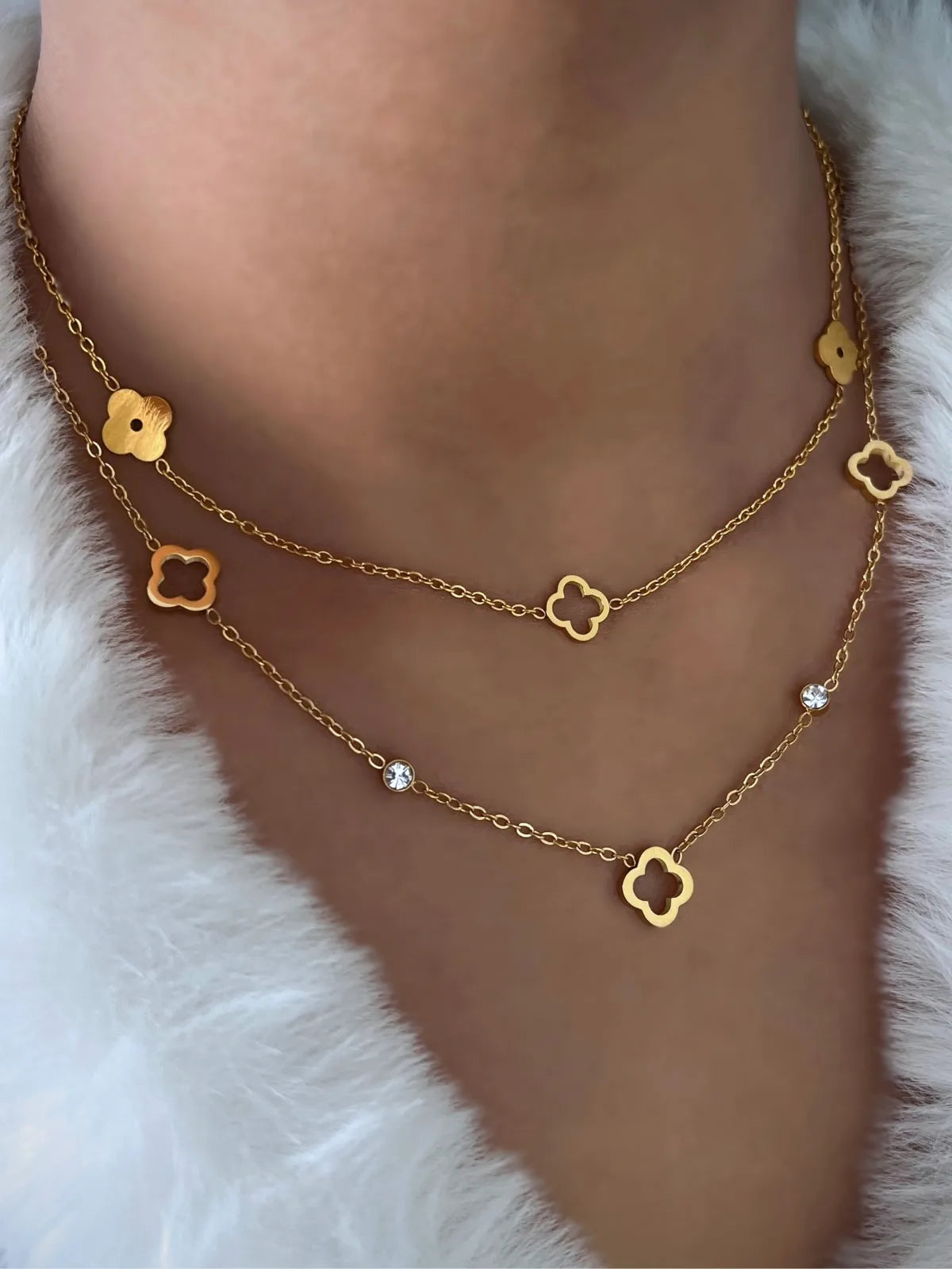 Close-up of Dua Clover Necklace by Shine With Me showing the 18K gold-plated finish, stainless steel base, and clover motif with zirconia.