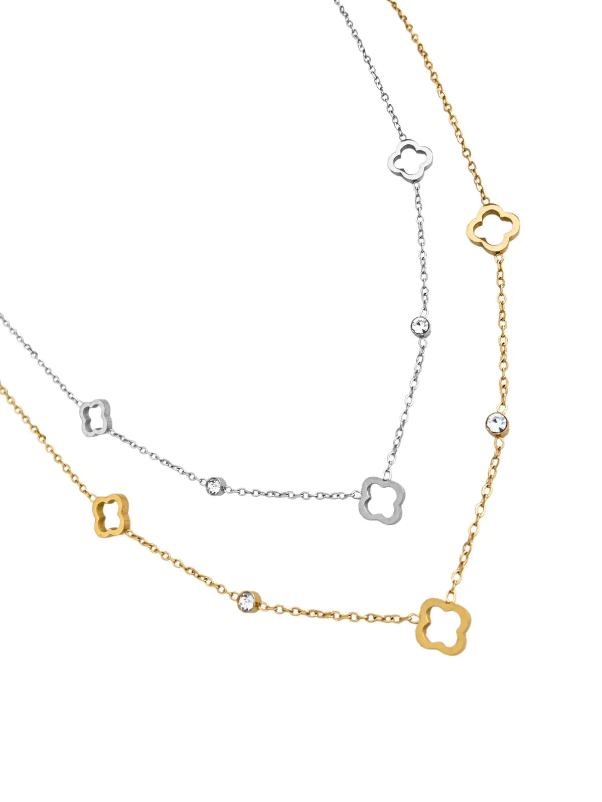 Dua Clover Necklace by Shine With Me displayed in both Gold & Silver variants — 18K gold-plated stainless steel with cubic zirconia, chain 42 cm + 5 cm