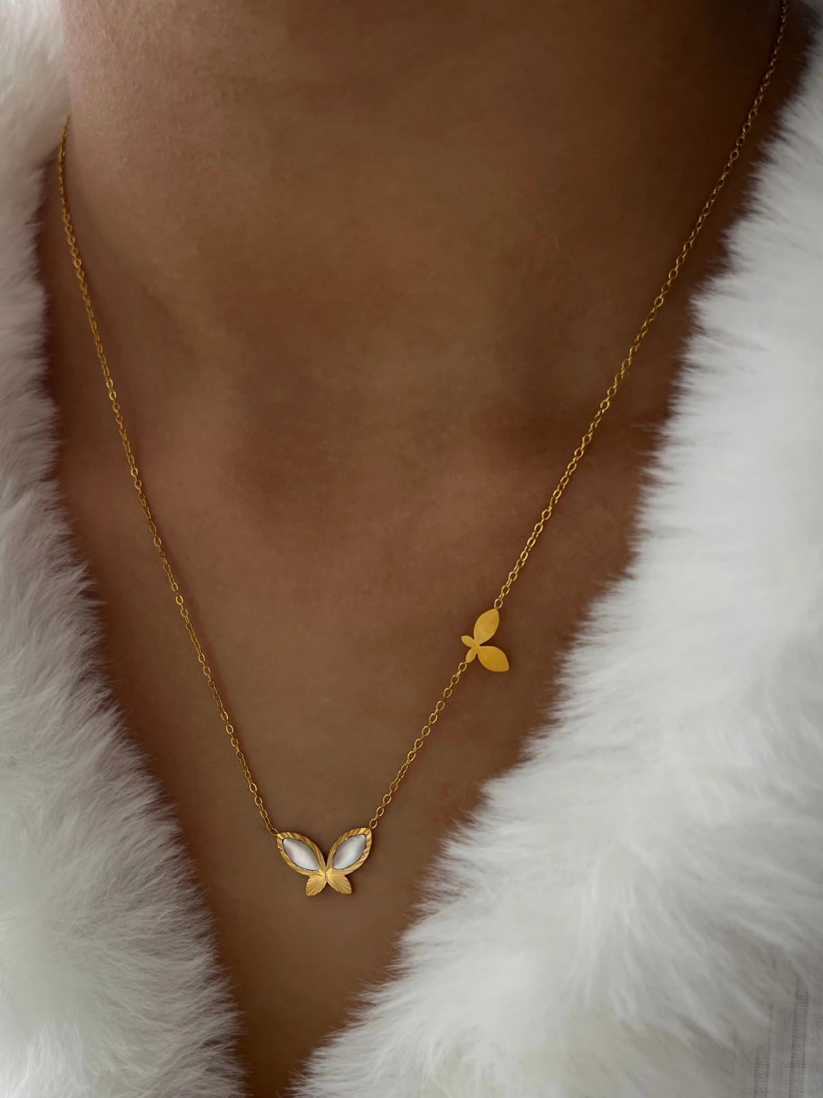 Fayra Wing Necklace worn around neck — 18K gold-plated stainless steel (chain 43 cm + 4 cm) by Shine With Me, styled look.