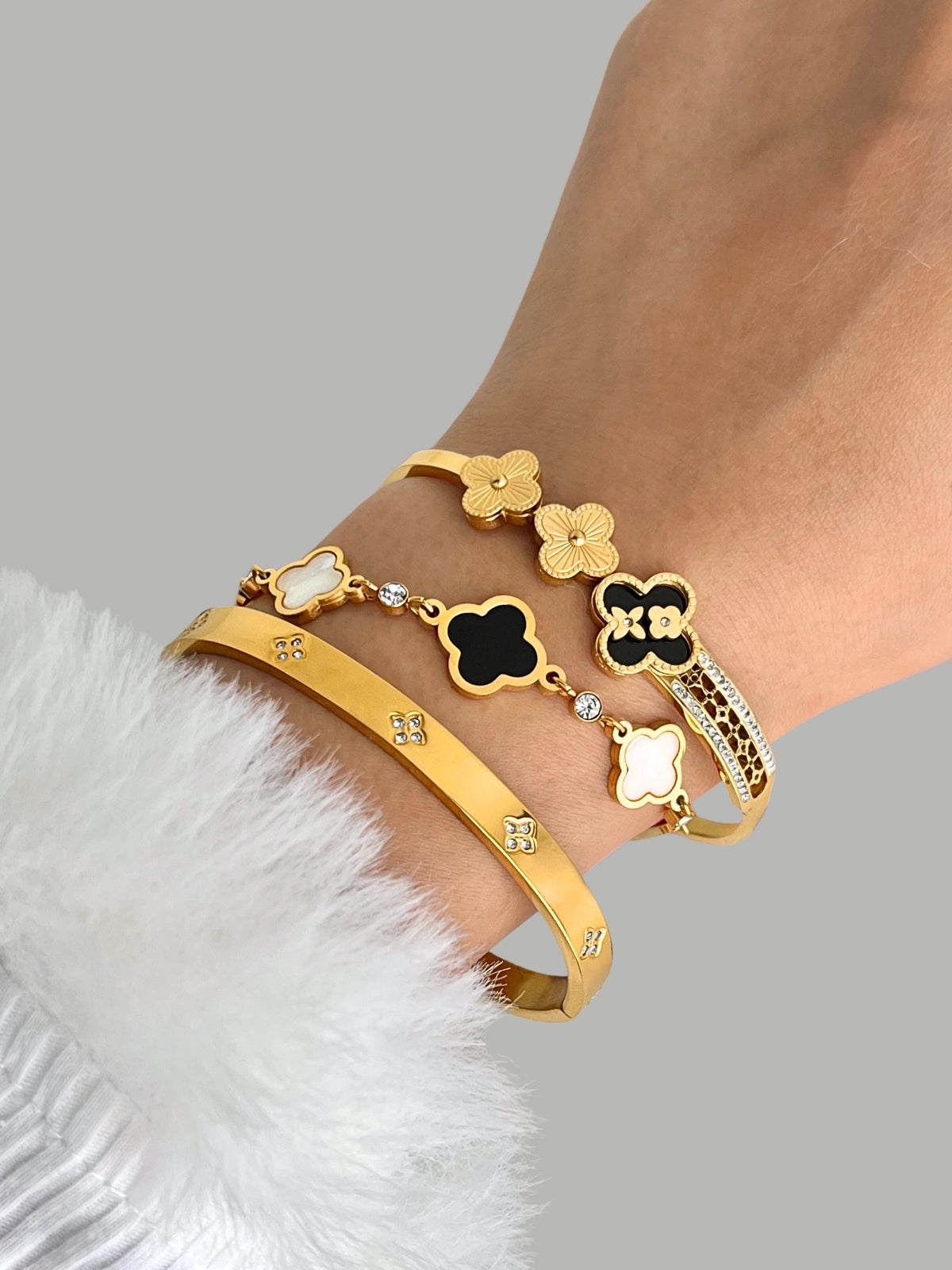 Goldra Clover Bracelet worn on wrist — gold-plated stainless steel bracelet by Shine With Me, elegant clover design for everyday grace.