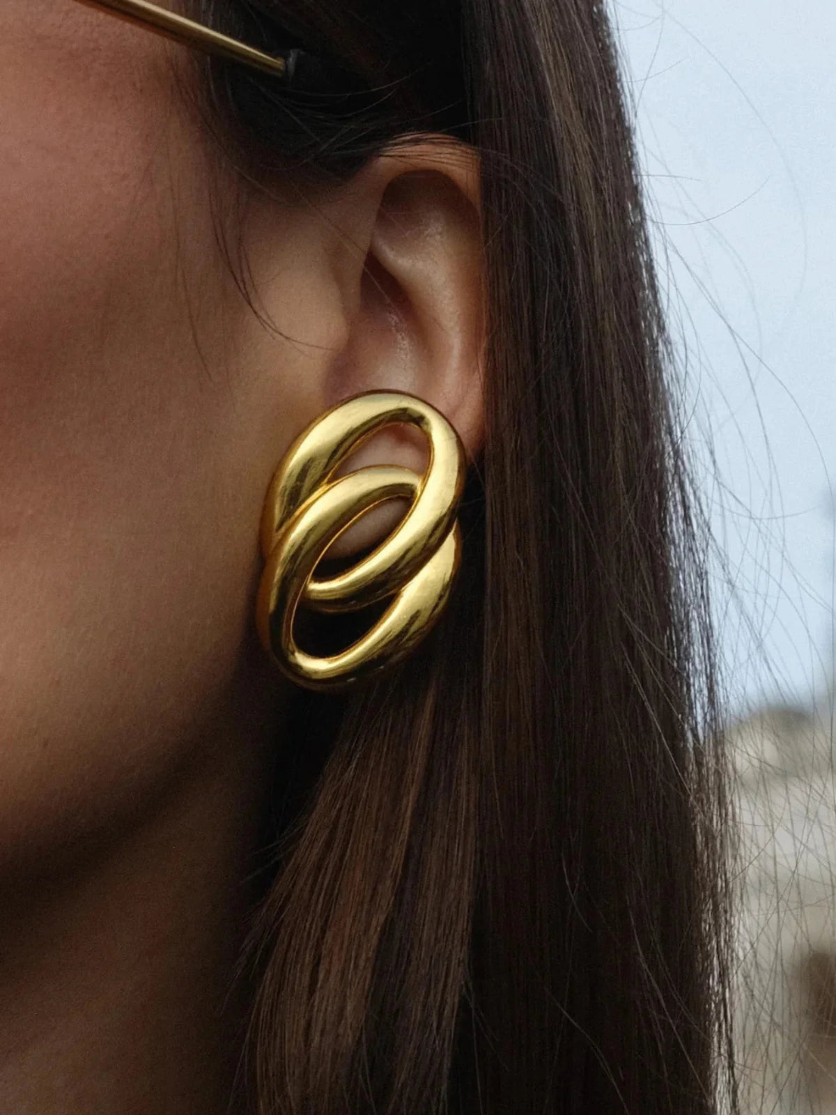 Gomez Earring worn on ear — 33 mm 18K gold‑plated stainless steel hoop by Shine With Me, styled look.