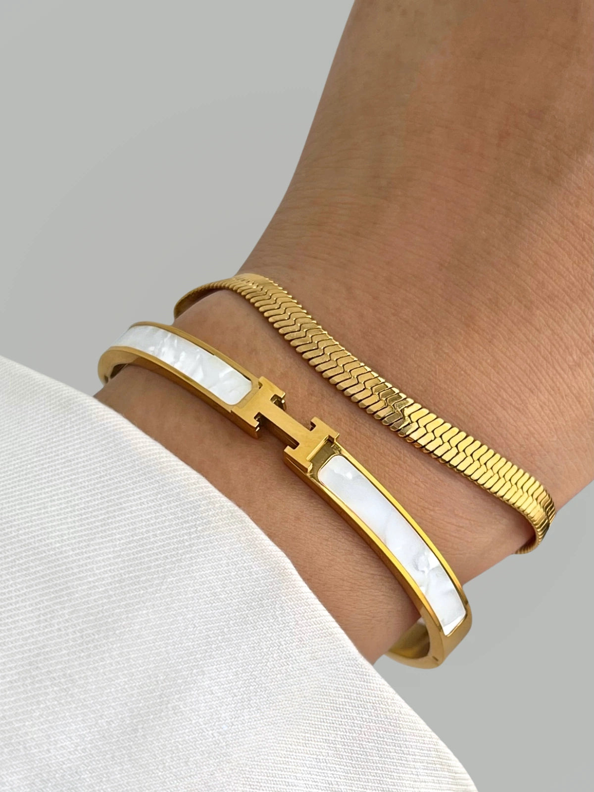 Haven H Bangle luxury gold-plated bracelet by Shine With Me, front view featuring floral motif and polished finish.