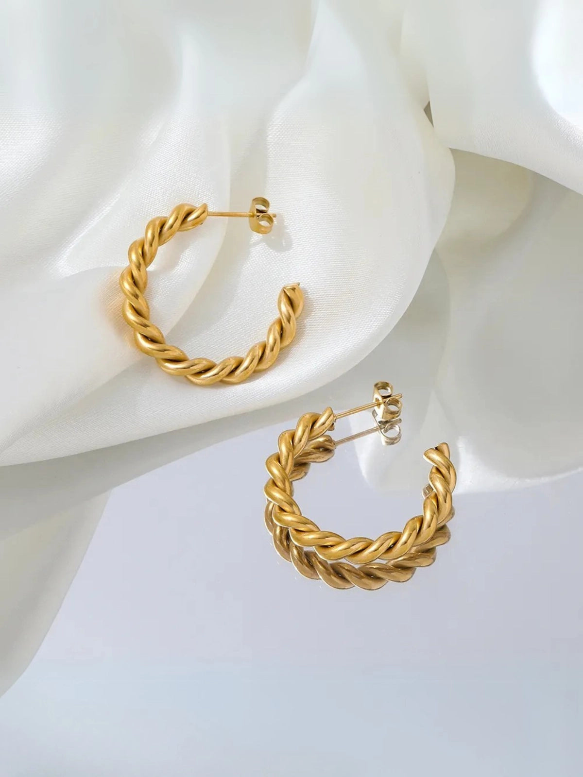Helen Hoop Earring – Close‑Up Detail-Gold hoop earrings on a white fabric background