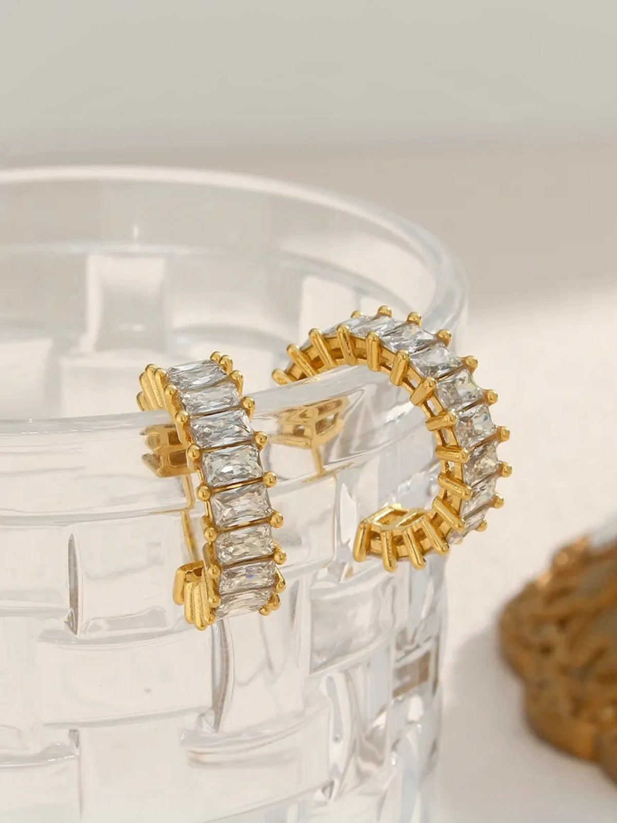 Close‑up of Ingrid Hoop Earring by Shine With Me showing gold‑plated finish, stainless steel base and cubic zirconia accents.