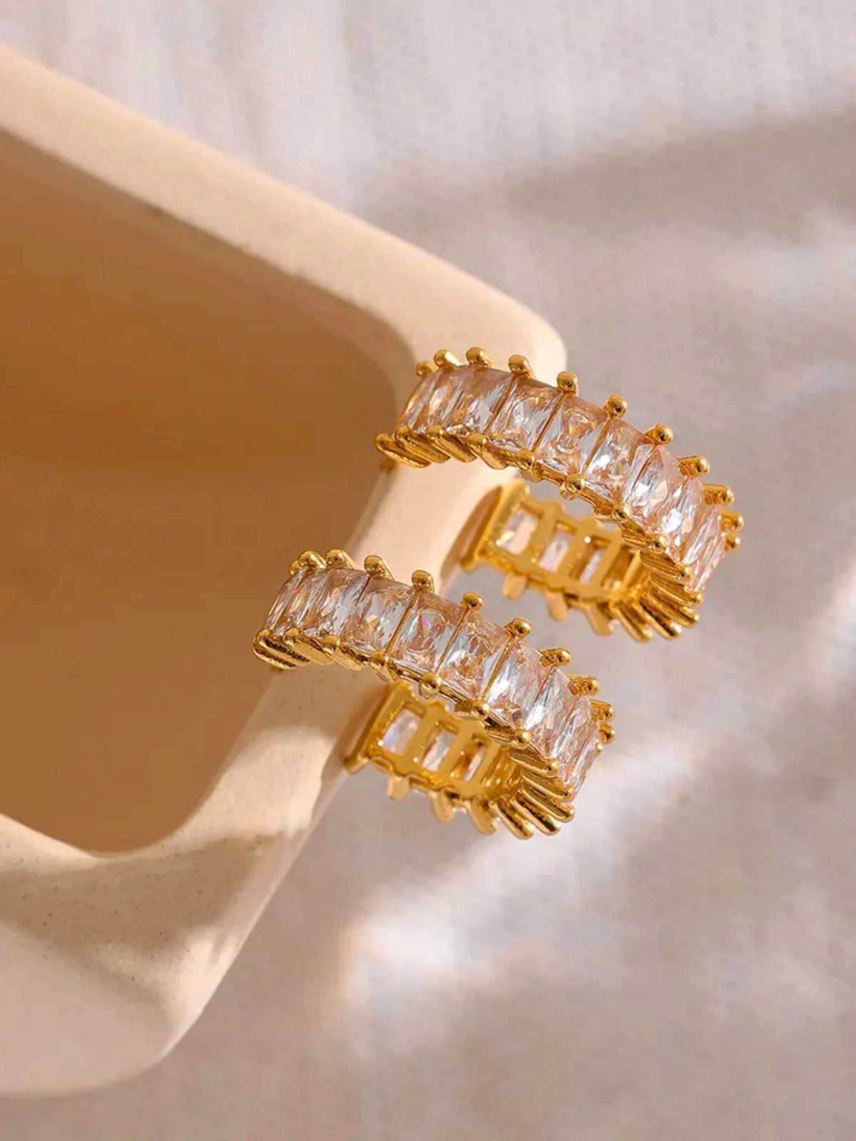 Close‑up of Ingrid Hoop Earring by Shine With Me showing gold‑plated finish, stainless steel base and cubic zirconia accents.