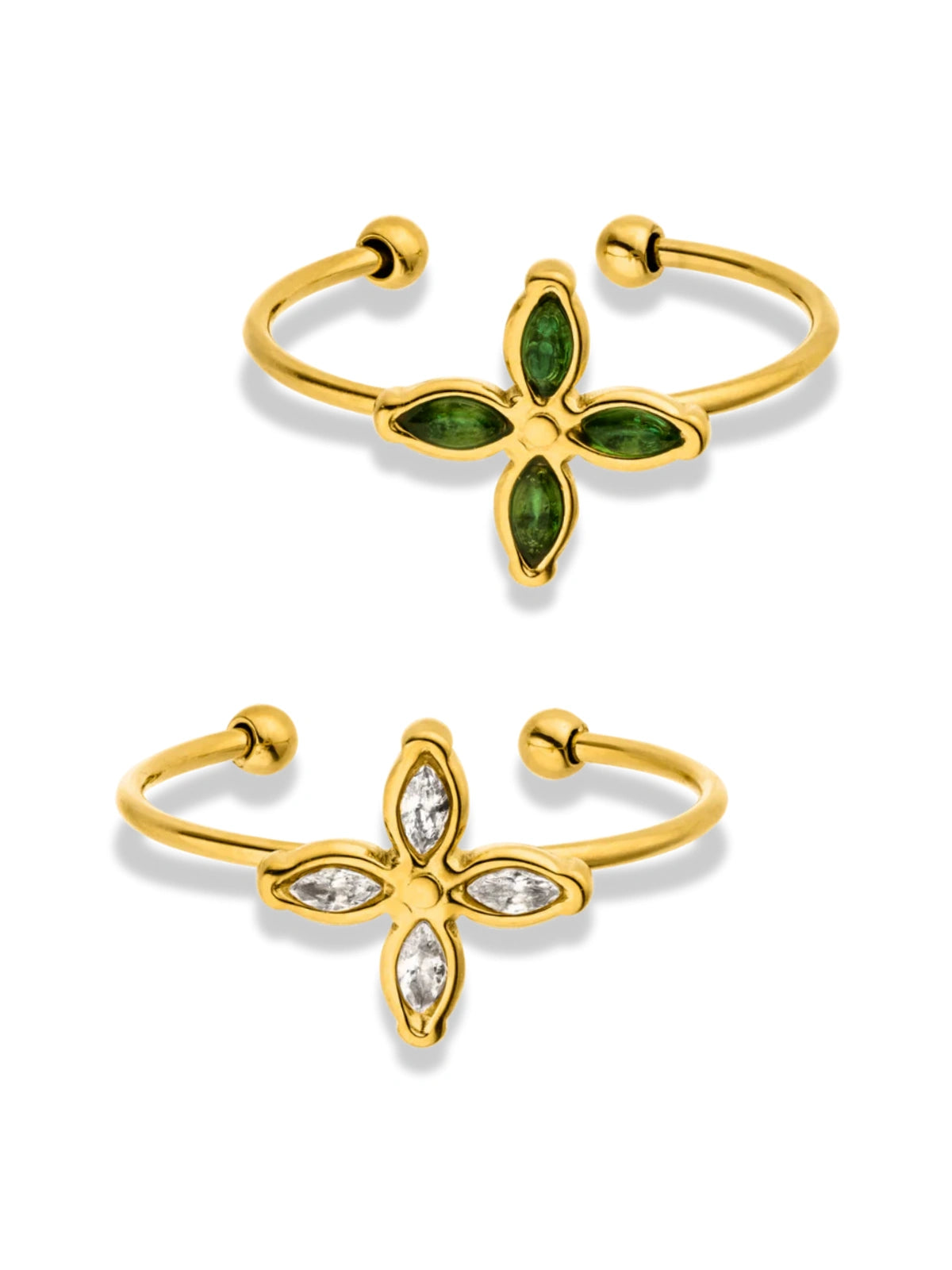 Two gold-colored rings with one featuring a floral design and the other with a geometric pattern, both with small inset stones.
