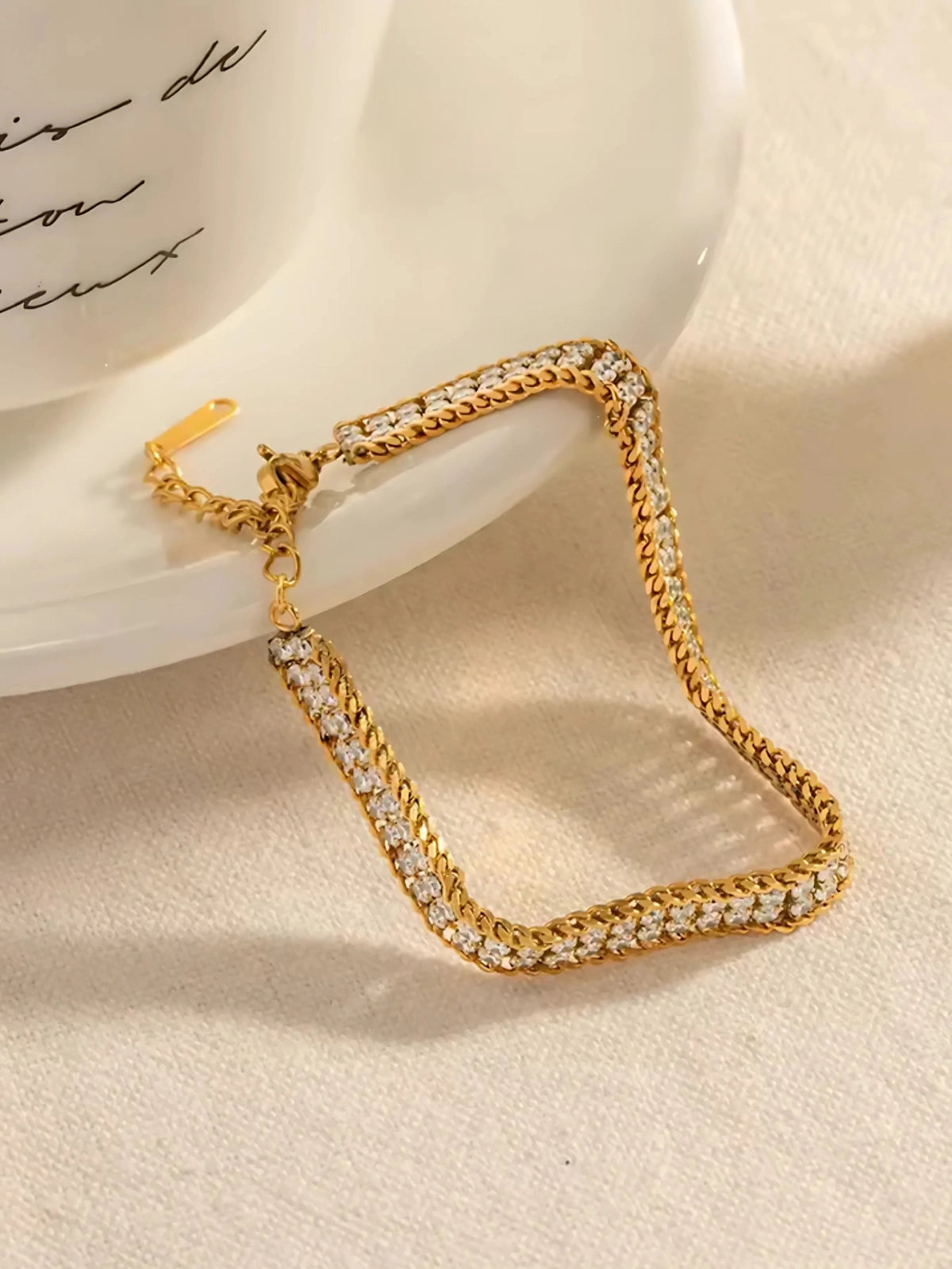 Noor bracelet with clear stones on a beige surface