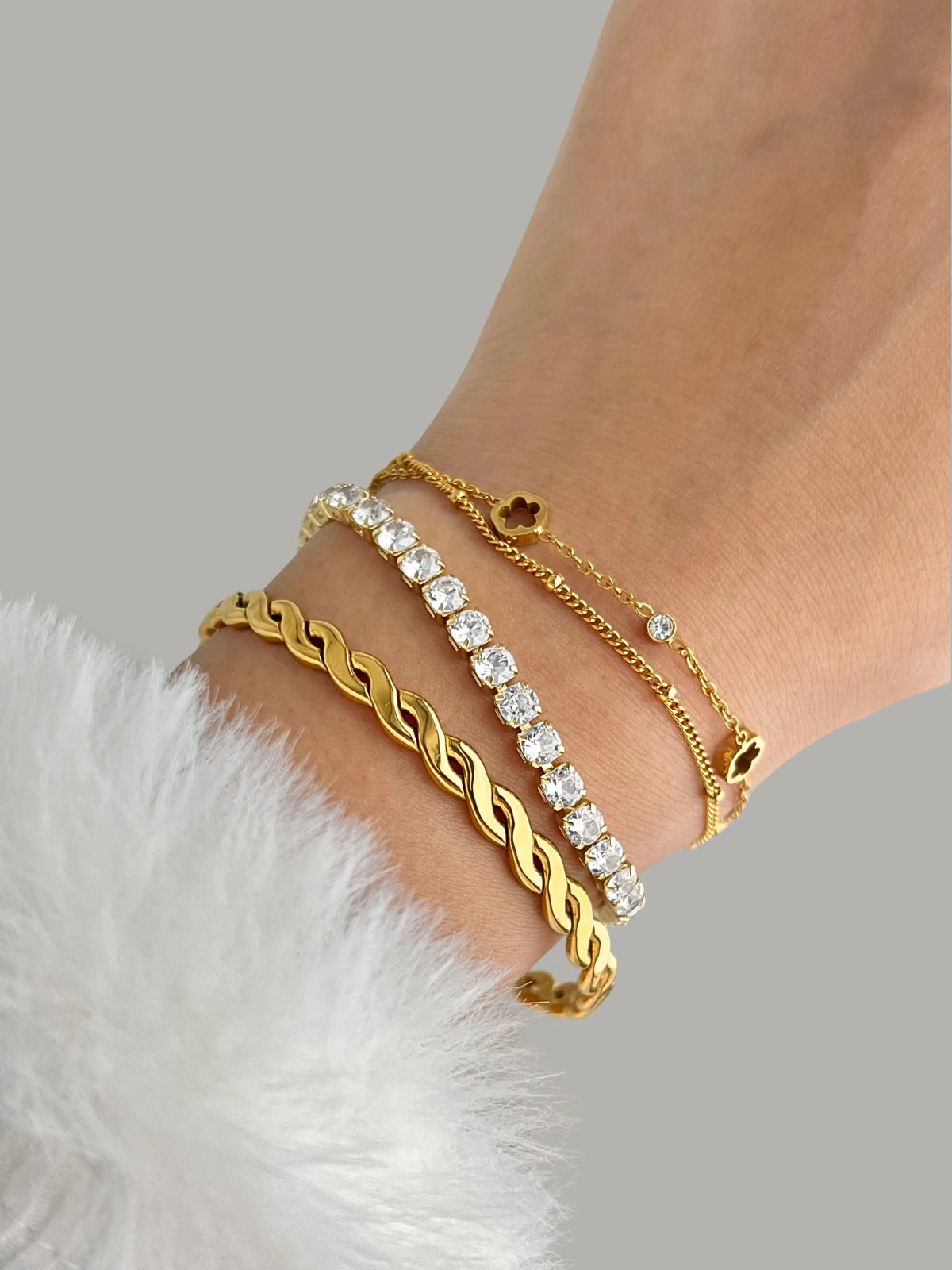 Sarena Bracelat Gold and diamond bracelet on a wrist with a neutral background