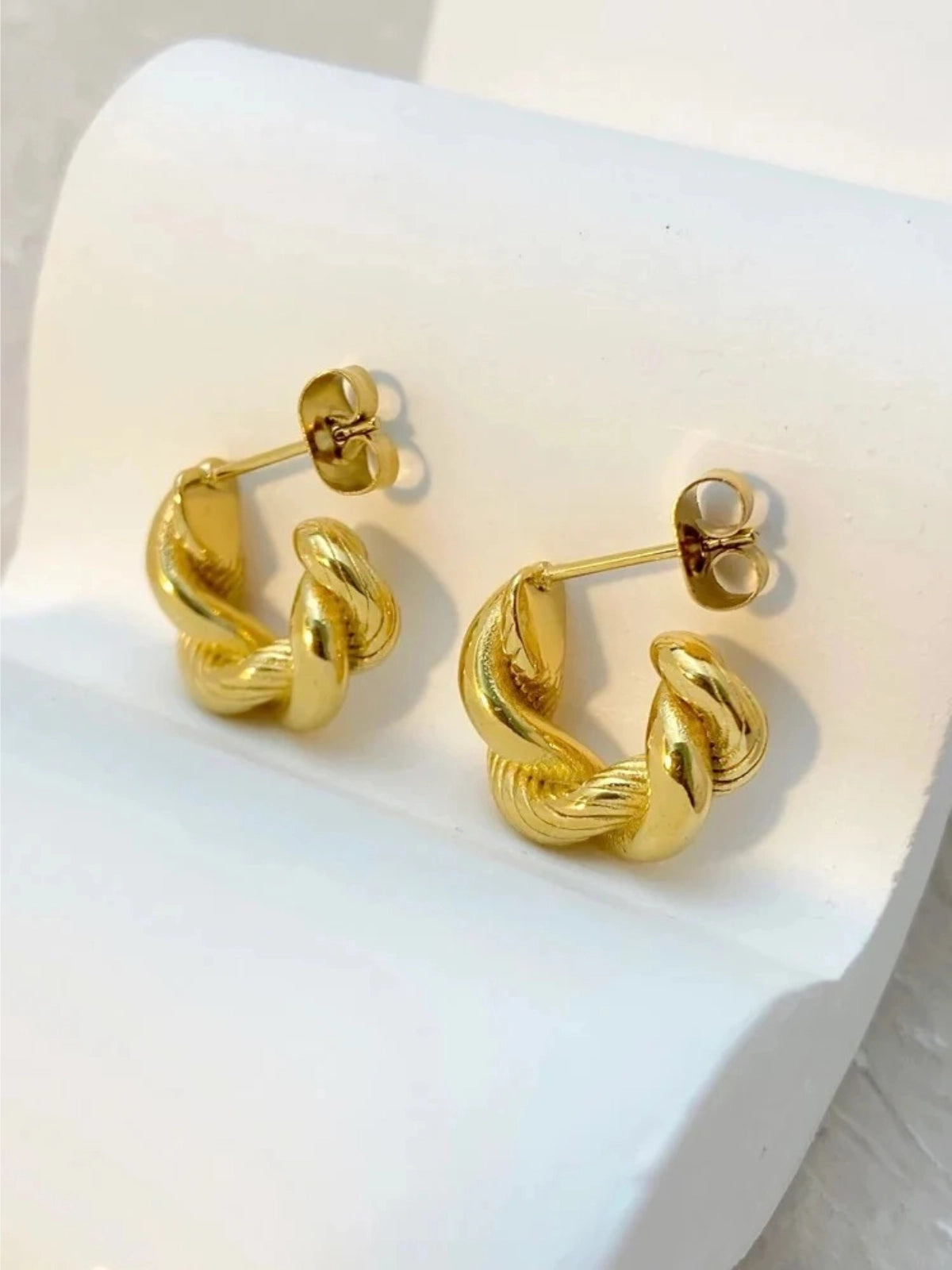 Sophie Hoop Earring – Close‑Up Detail-Gold hoop earrings on a white surface