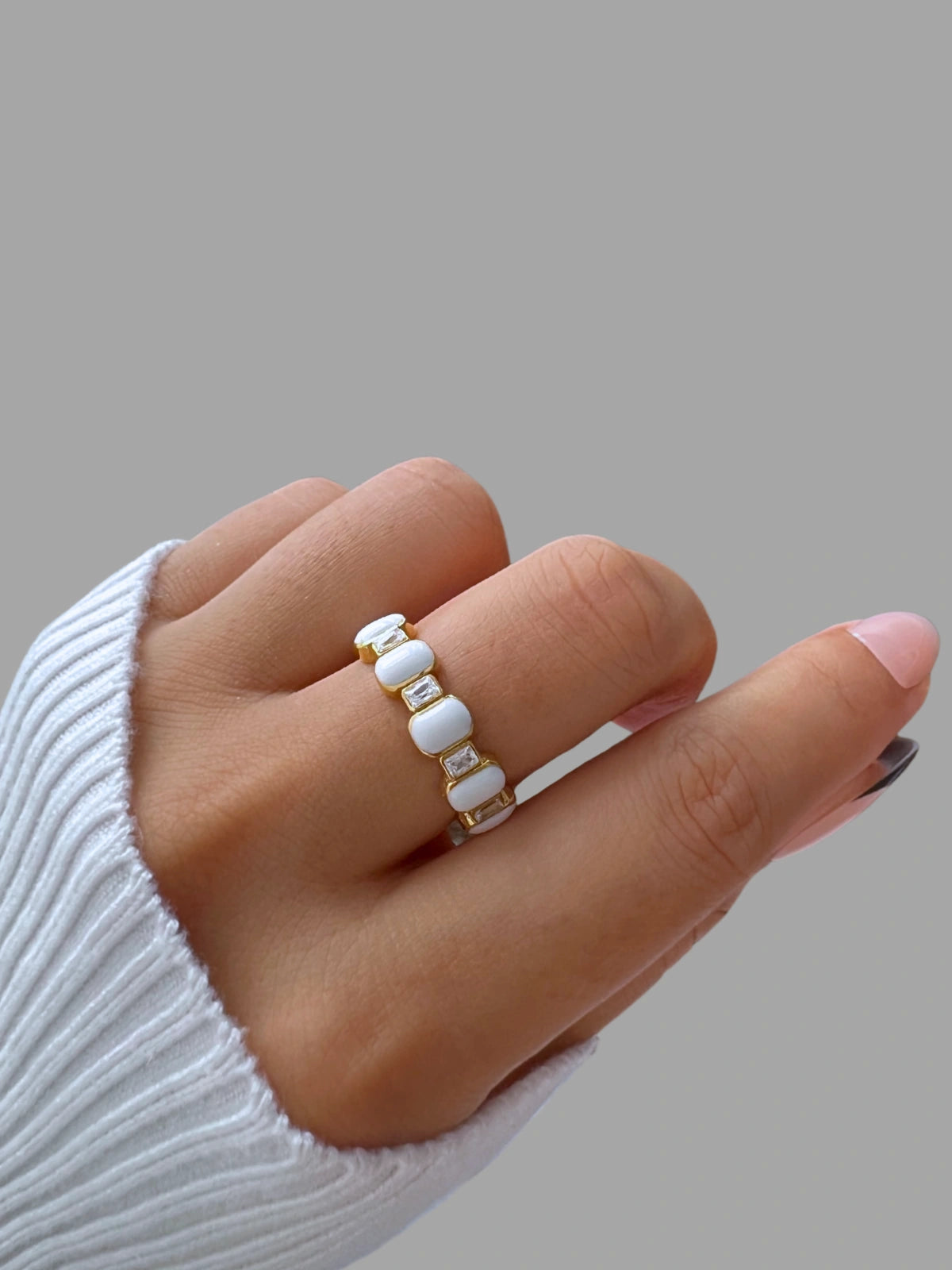 Zadia Ring | Shine With Me Hand wearing a ring with white beads on a neutral background