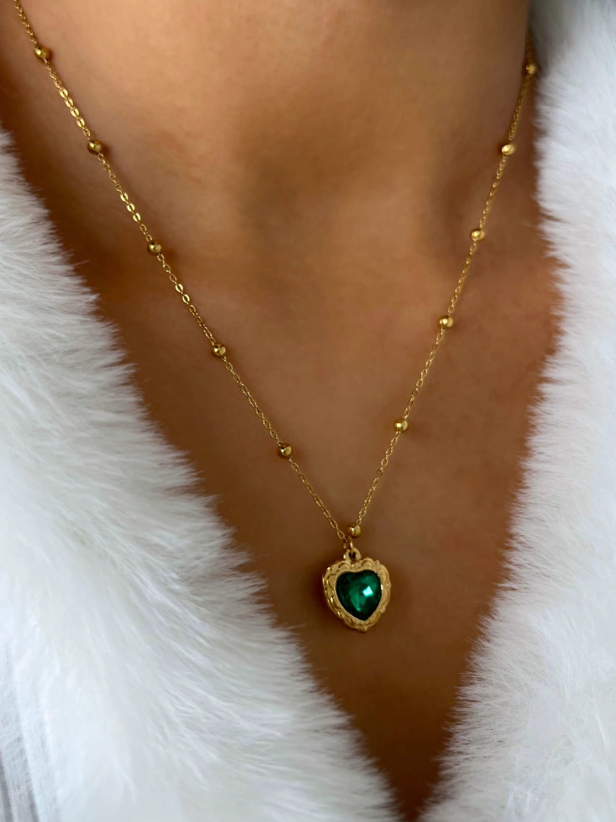 Zafira Necklace worn on neck — 18K gold‑plated stainless steel chain (43 cm + 6 cm) with green heart pendant by Shine With Me, styled look.