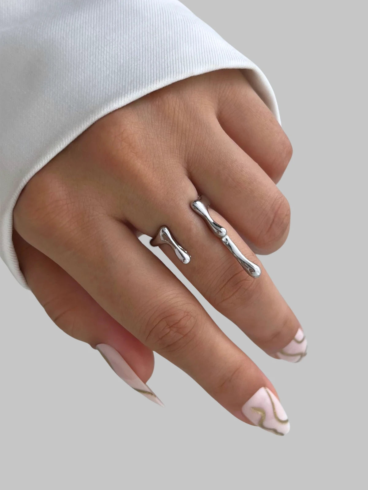 aqua-ring-lifestyle-shot-shine-with-me Silver ring on a finger with a plain background