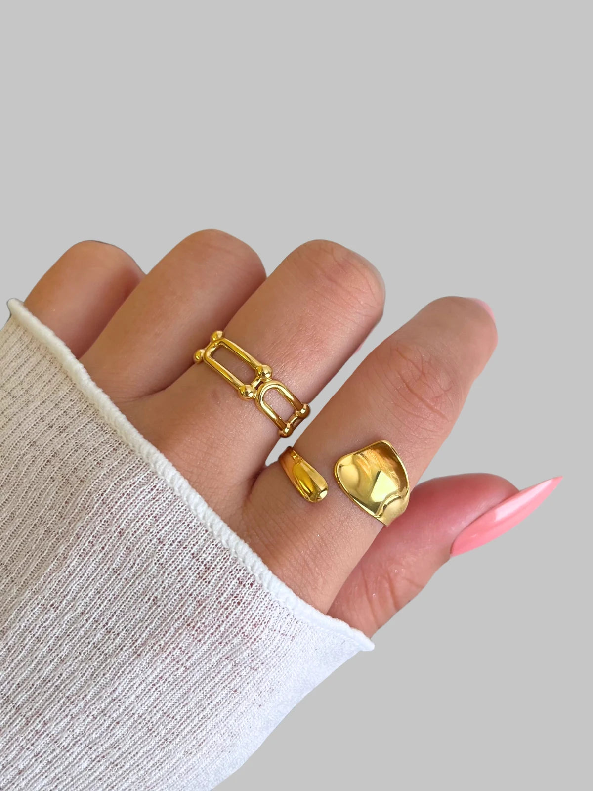 daily-rings-closeup-detail-shine-with-me Gold rings on a hand with a neutral background