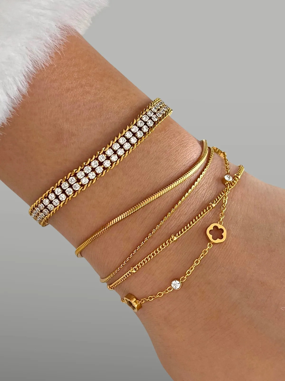 Noor bracelet with various designs on a wrist against a neutral background