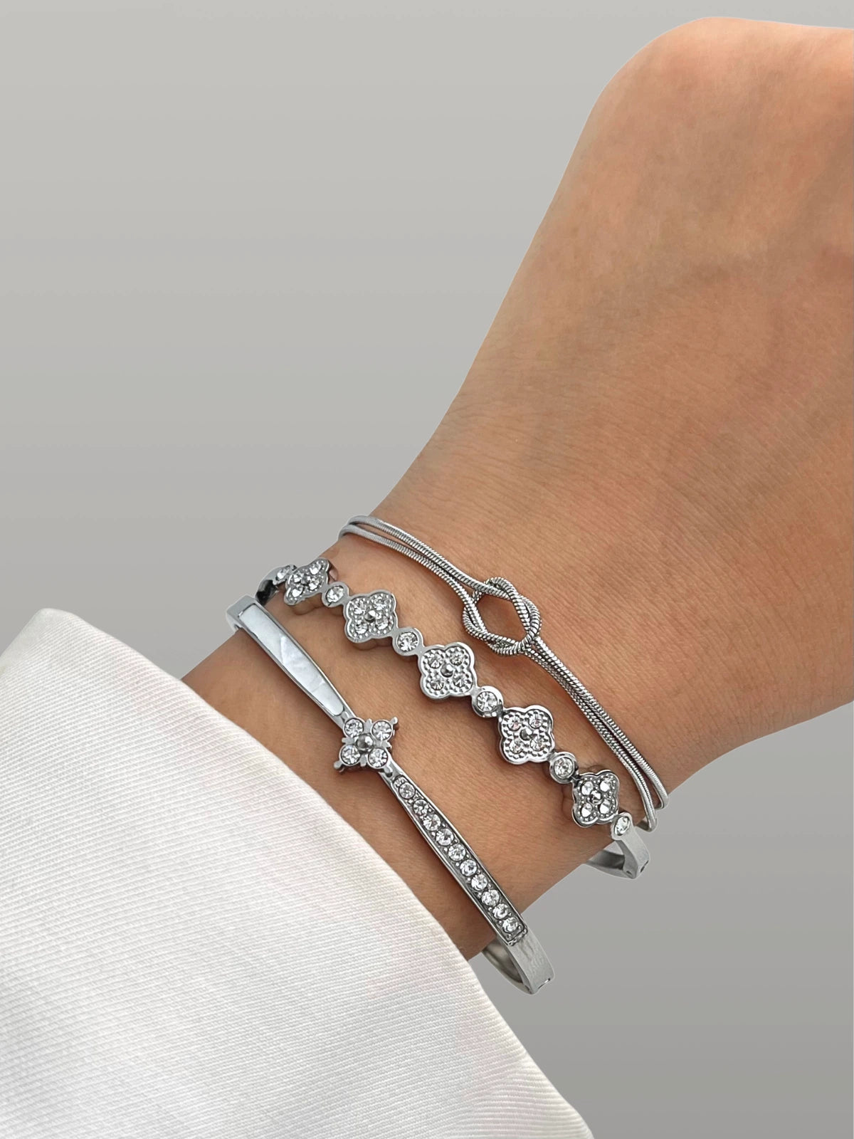 Clovelly Bangle styled with other bracelets by Shine With Me — Silver bangle layering with modern sophistication and subtle shine