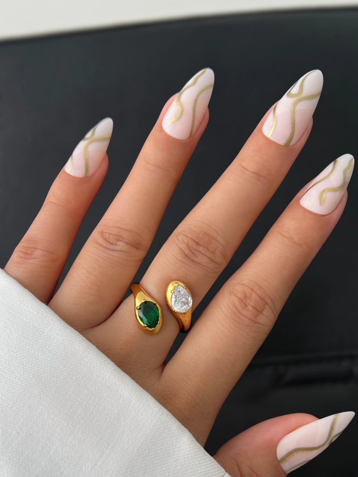 Alexandra Ring – Close‑Up Detail-Hand with marble nail design wearing two rings on a neutral background
