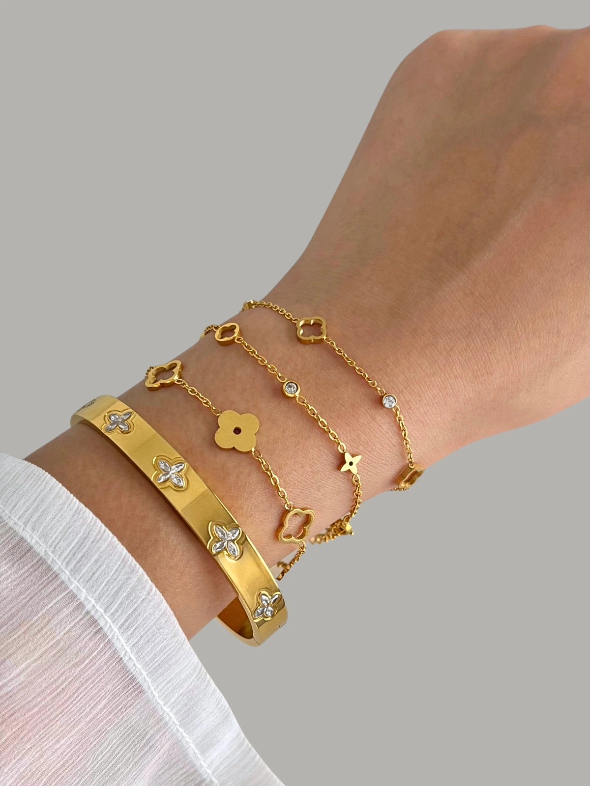 Close-up of Callie Bangle by Shine With Me, showcasing high-polish gold plating and modern curved edges.