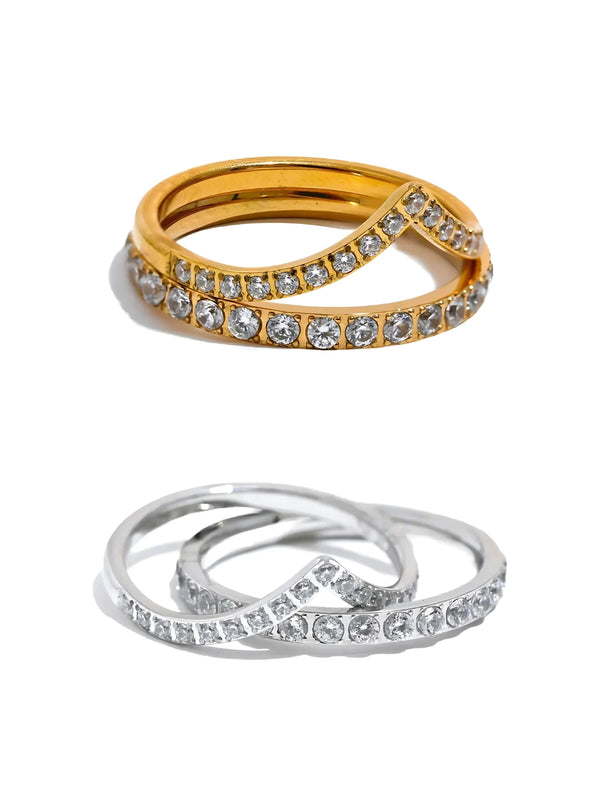 Camille Ring Two rings, one plated in gold with cubic zirconia stones, and the other in silver with a similar design, both displayed against a white background.