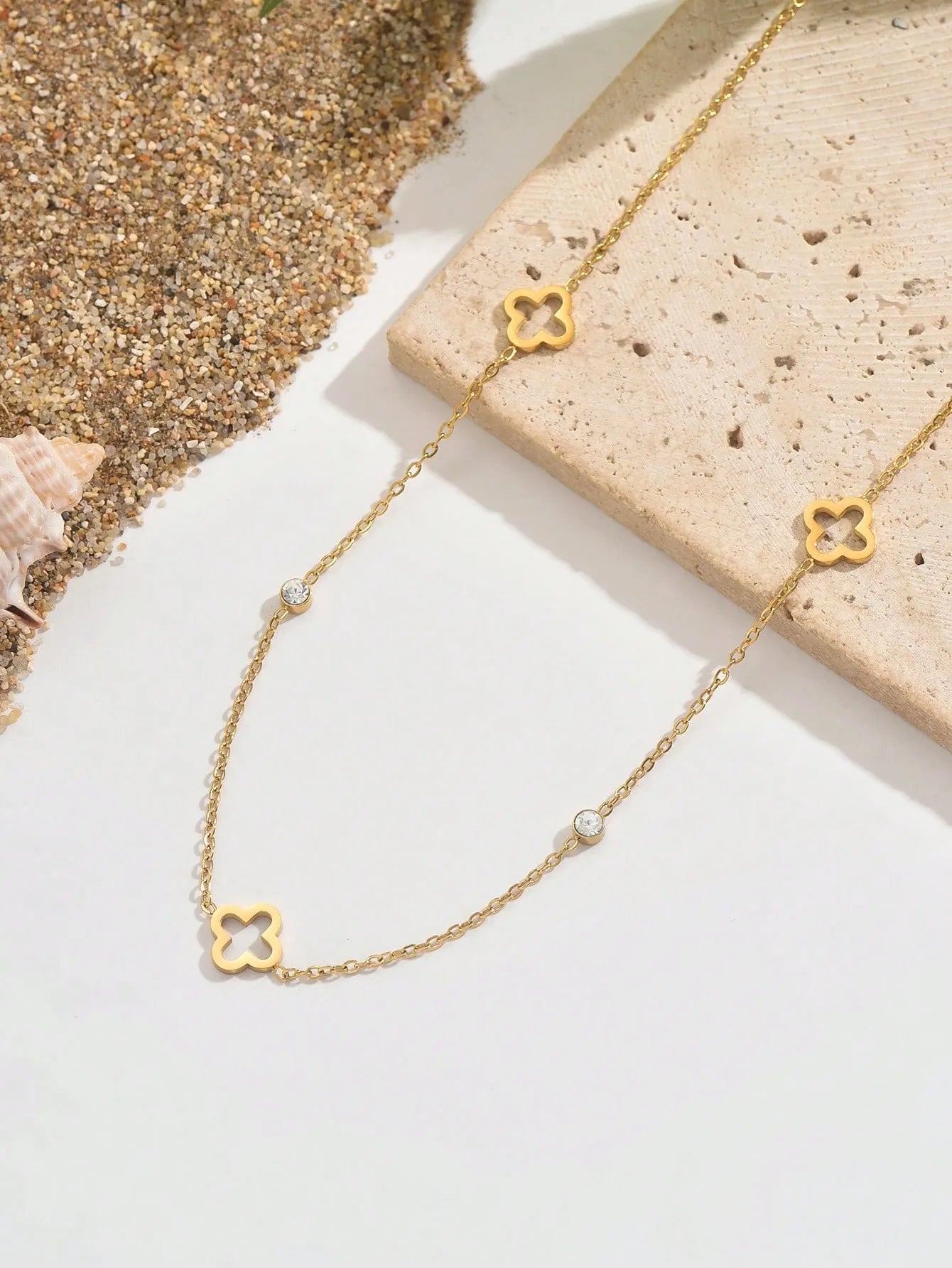 Dua Clover Necklace – Close-Up Detail-Gold necklace with clover-shaped links on a light background