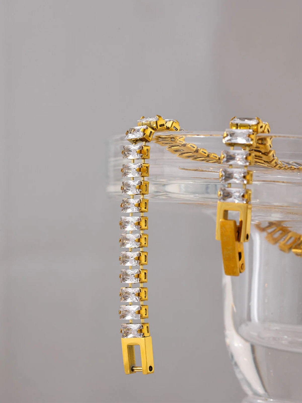 Elly Bracelet luxury 18K gold-plated stainless steel bracelet by Shine With Me, front view. Gold bracelet with clear gemstones on a white background