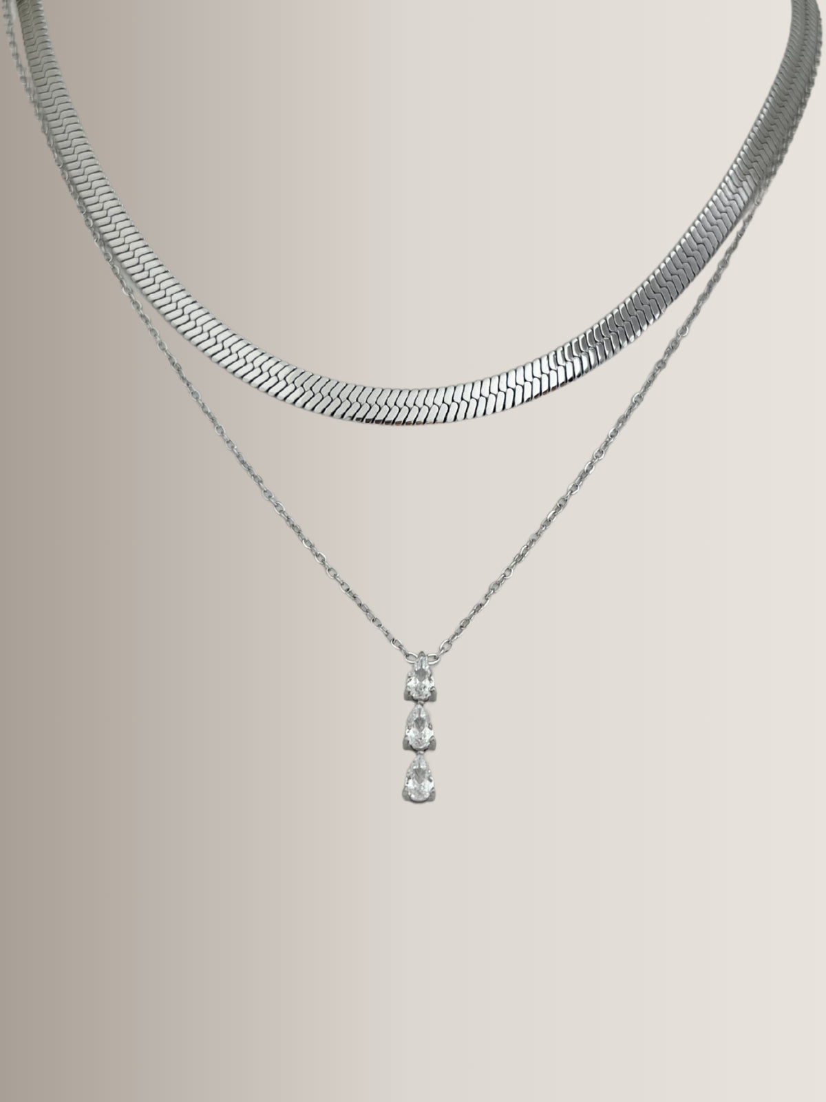 Gina Necklace – Close‑Up Detail-Silver necklace with a pendant on a light gray background