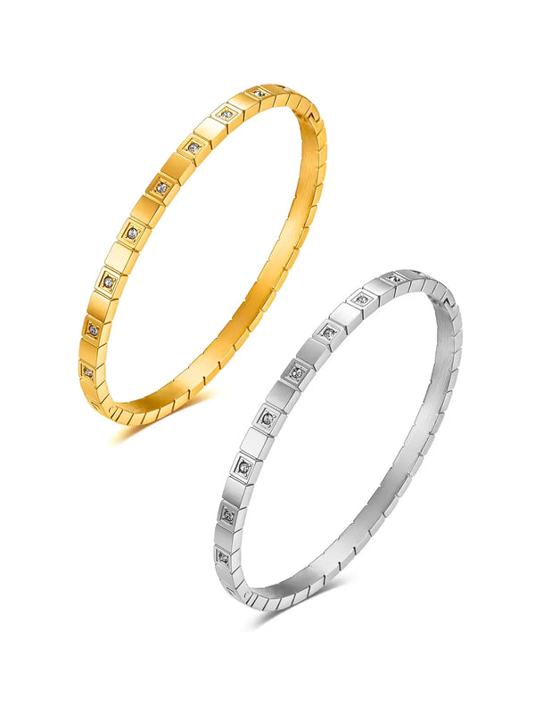 Selina Bangle Gold and silver with embedded stones on a white background