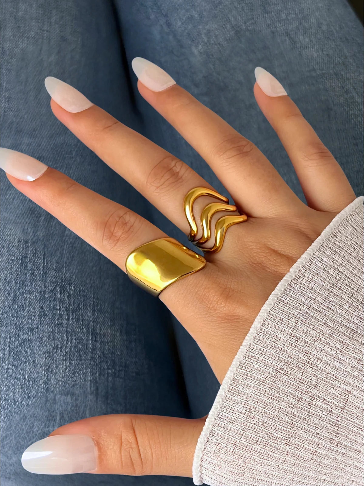 Golden Pulse Ring – Worn on Finger-Gold ring on a hand with a neutral background