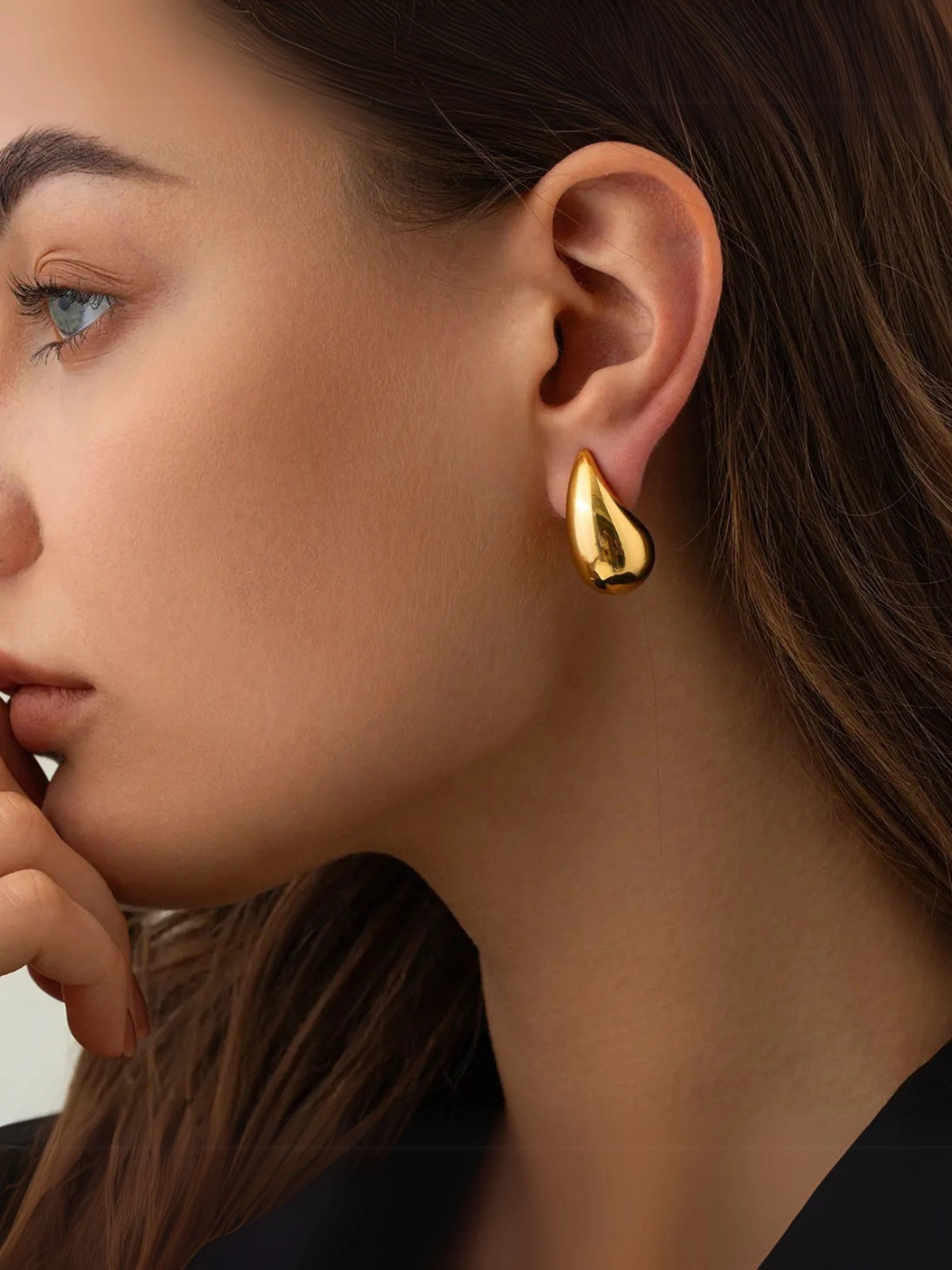 Madonna Drop Earring – On Ear Styled Shot-Close-up of a woman wearing a gold earring with a blurred background