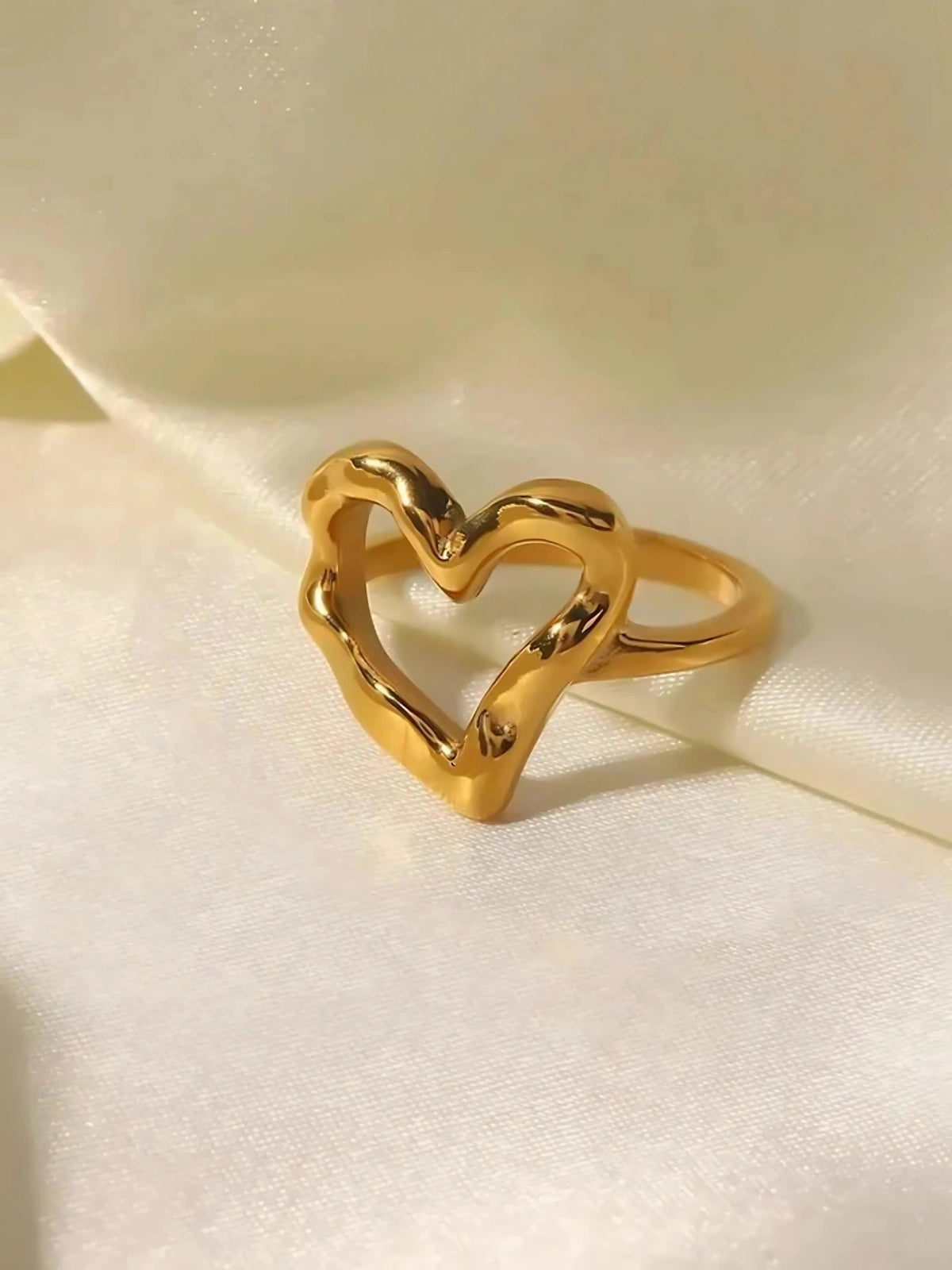 My Heart Loop Ring – Worn on Finger-Gold heart-shaped ring on a light fabric background