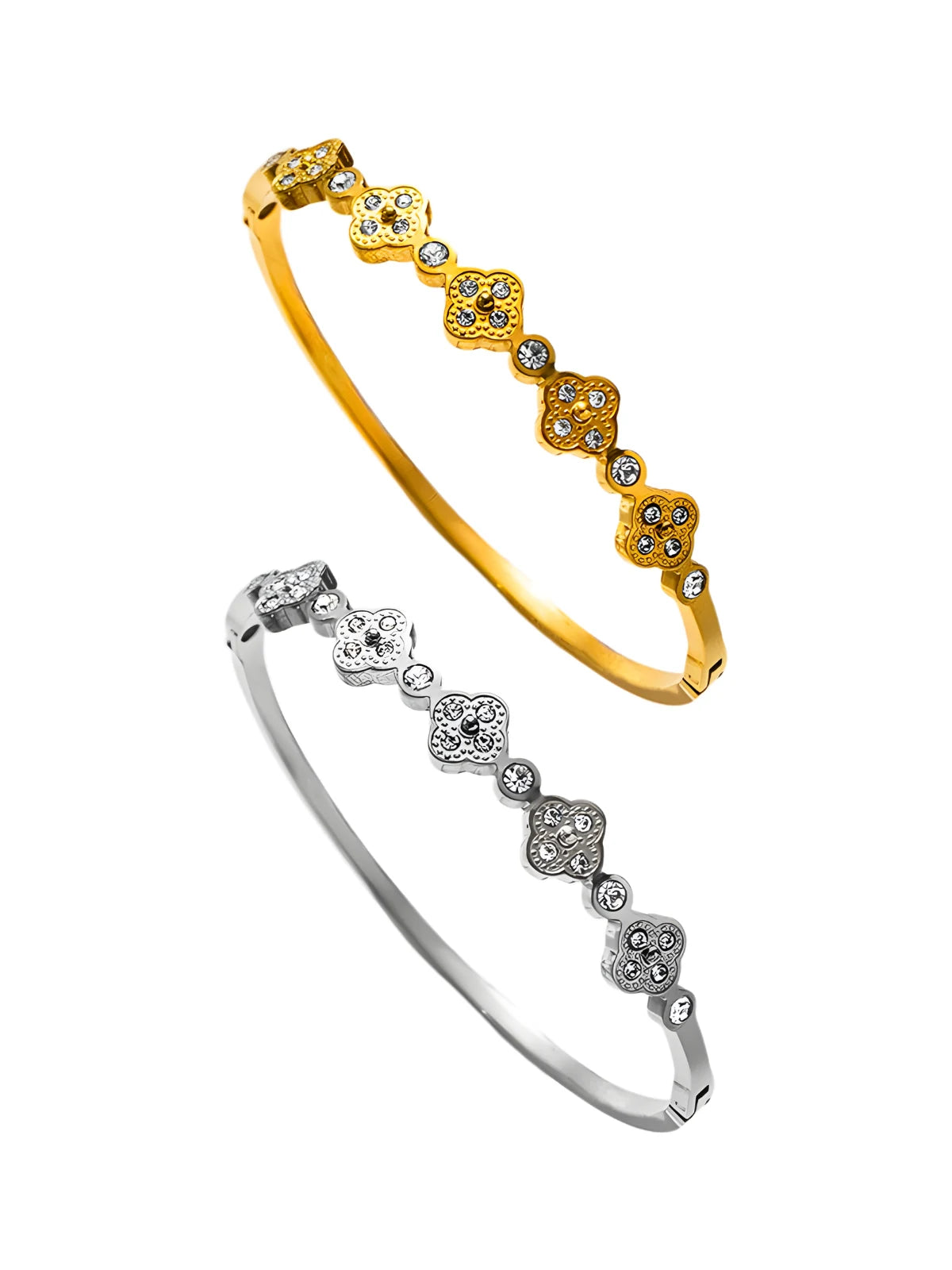 Gold and silver bangles with diamond-like stones on a white background