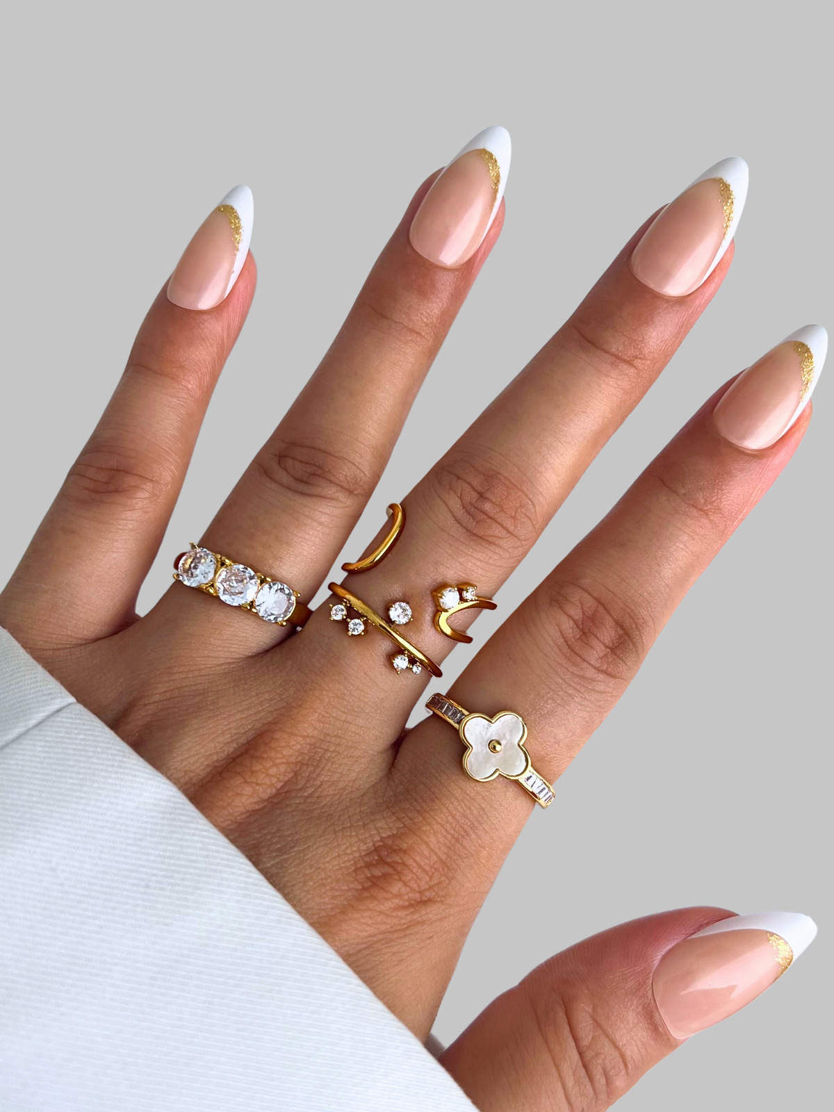 Pearl Bloom Ring – On Model Styled Shot-Hand wearing multiple gold rings with a plain background
