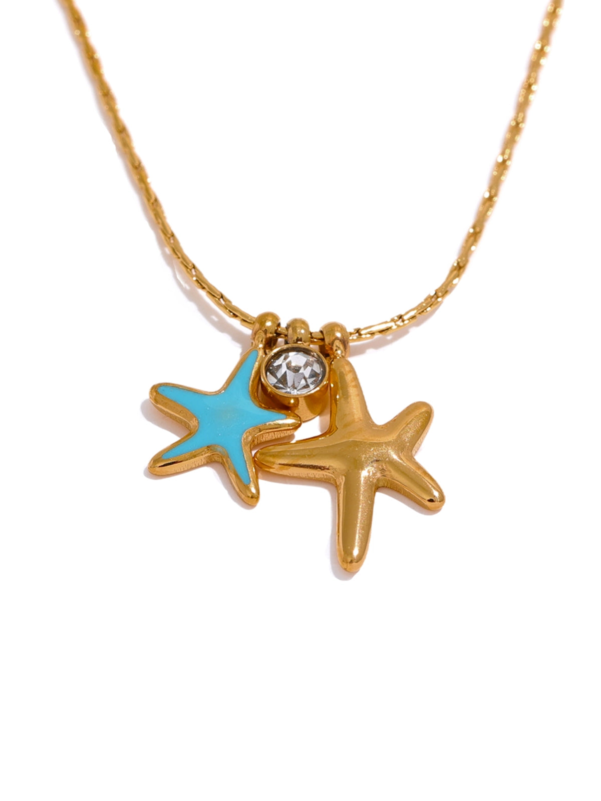 Seabell Necklace – Front View-Gold necklace with starfish pendants, one blue and one clear gemstone, on a white background