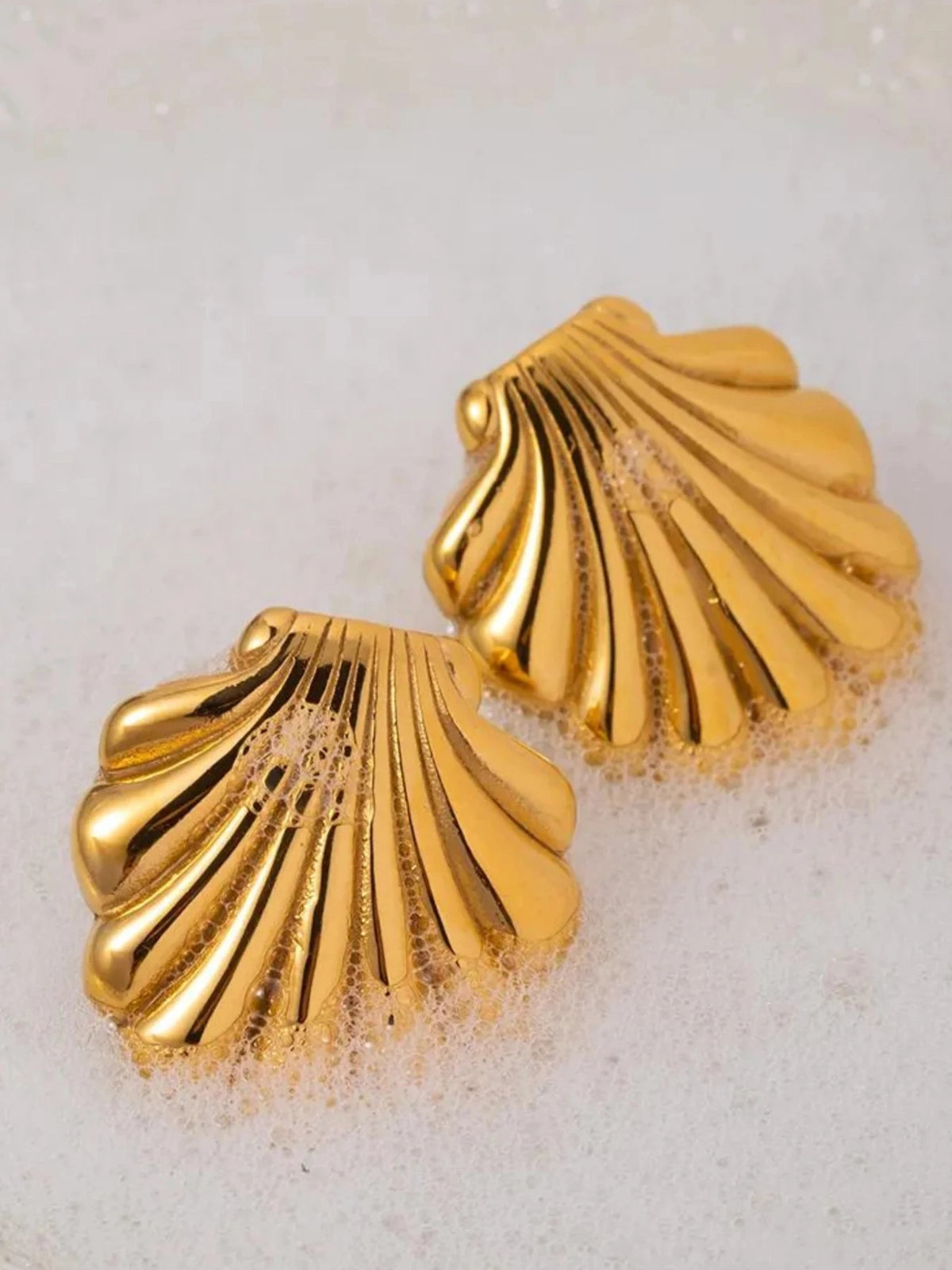 Shella Earrings – Close‑Up Detail-Gold shell-shaped earrings on a white background