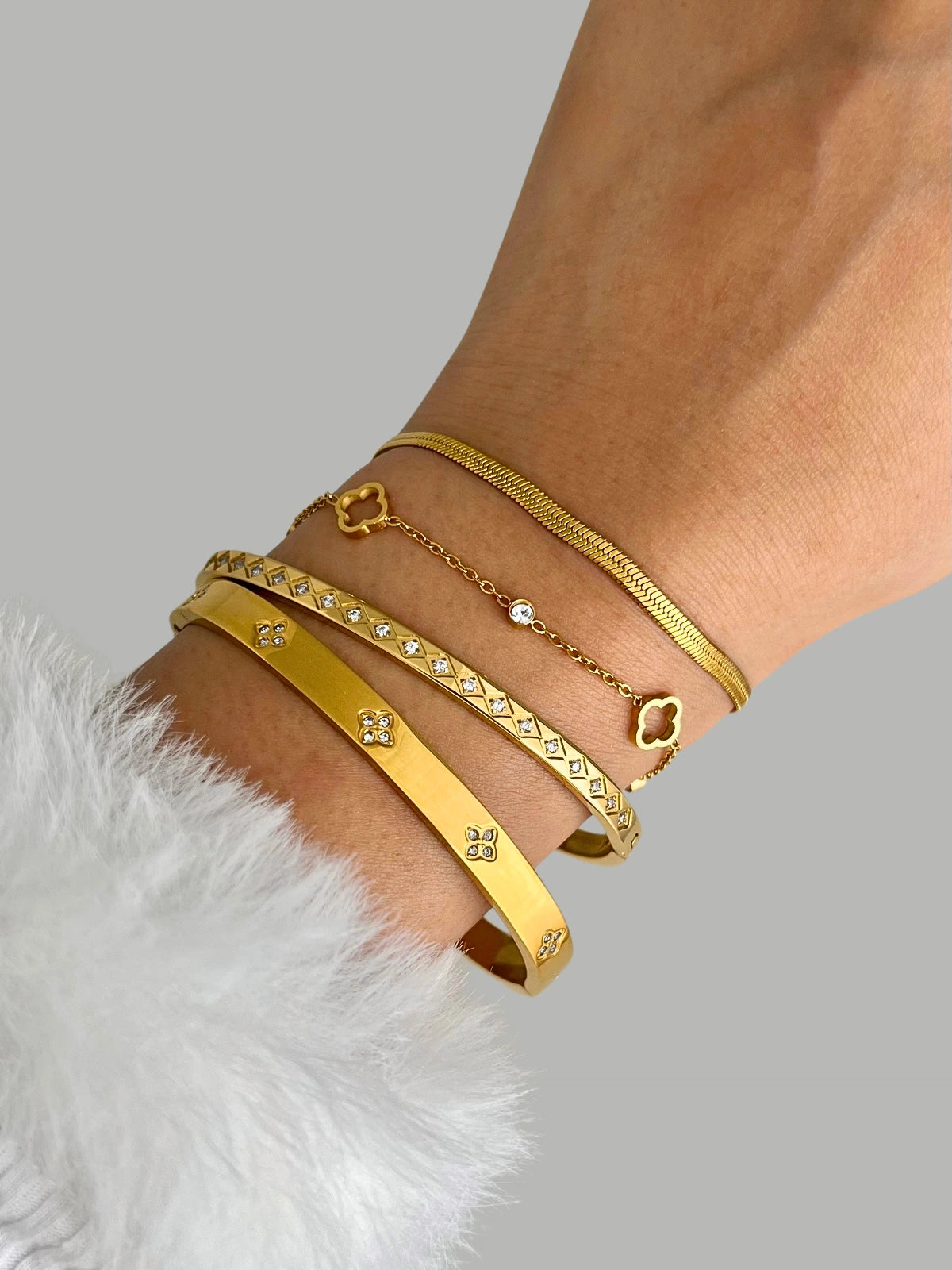 Snake Bracelet – On Wrist, Gold bracelets on a wrist with a neutral background