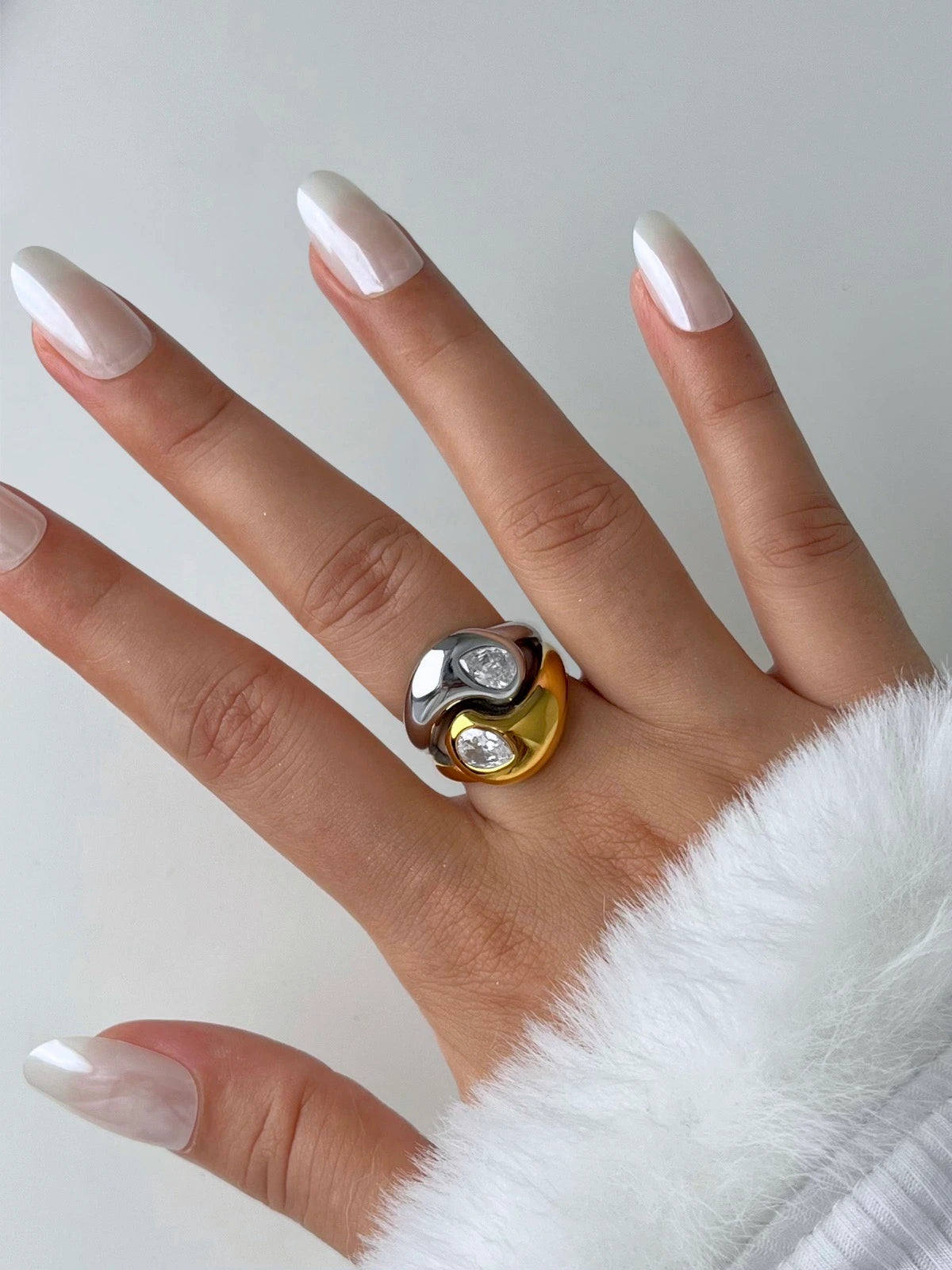 Starlet Ring | Shine With Me Hand wearing a ring with a white and gold design on a neutral background