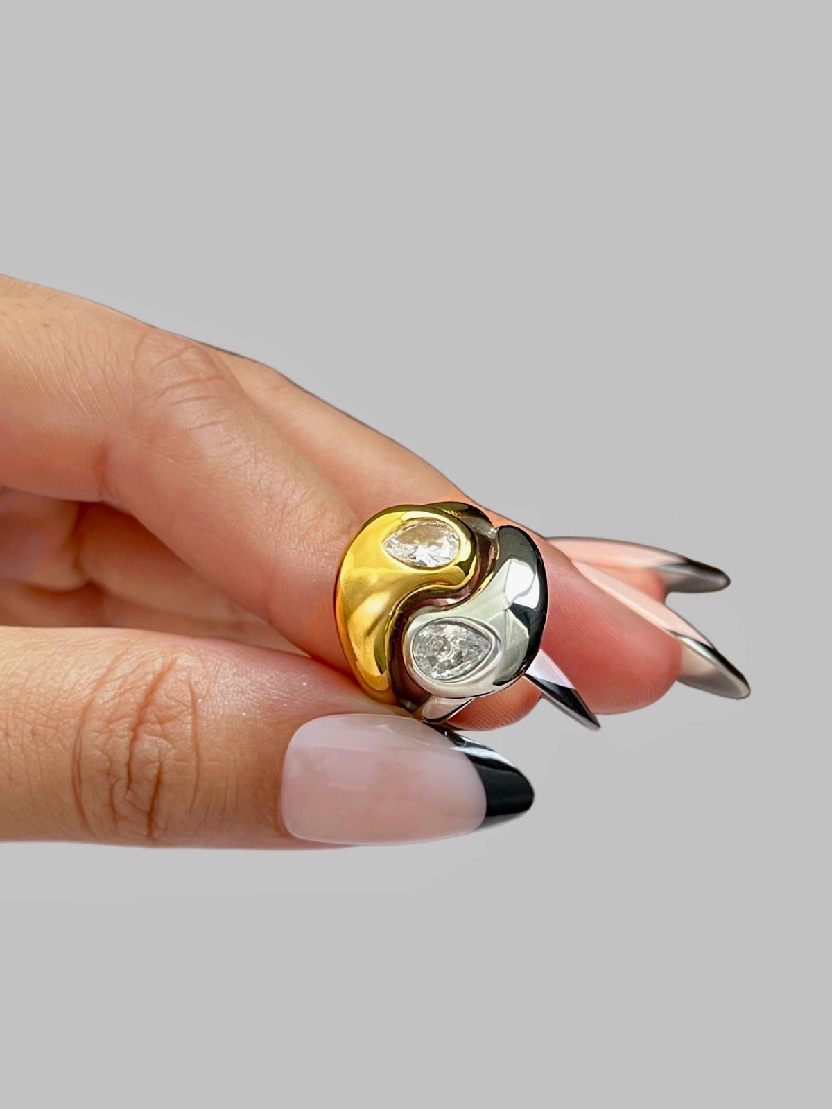 Starlet Ring | Shine With Me Gold and silver ring with two diamonds on a neutral background