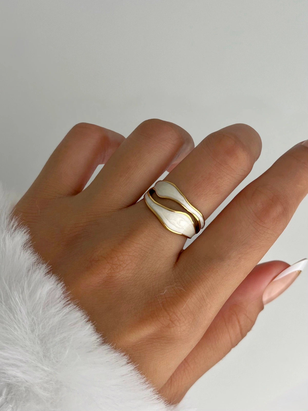 luxe-spiral-ring-side-angle-shine-with-me Gold ring on a finger with a neutral background