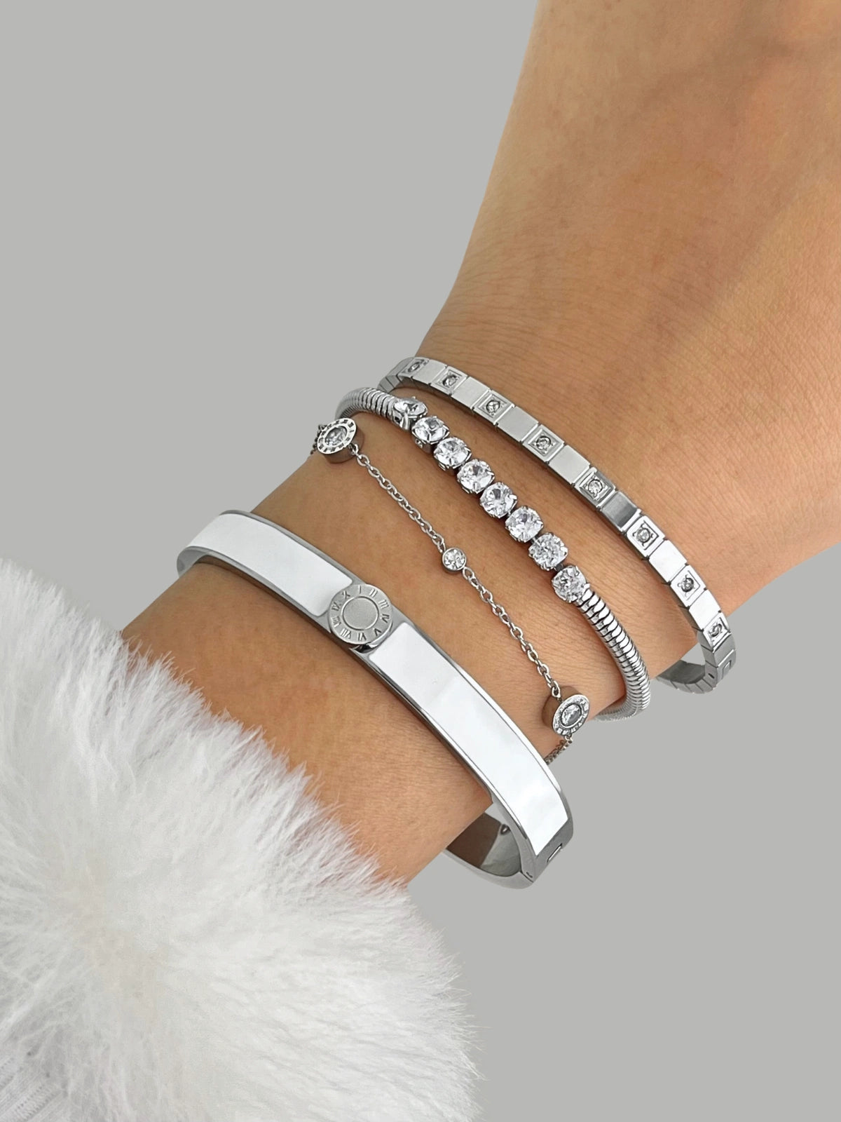 Selina Bangle Silver on a wrist with a neutral background